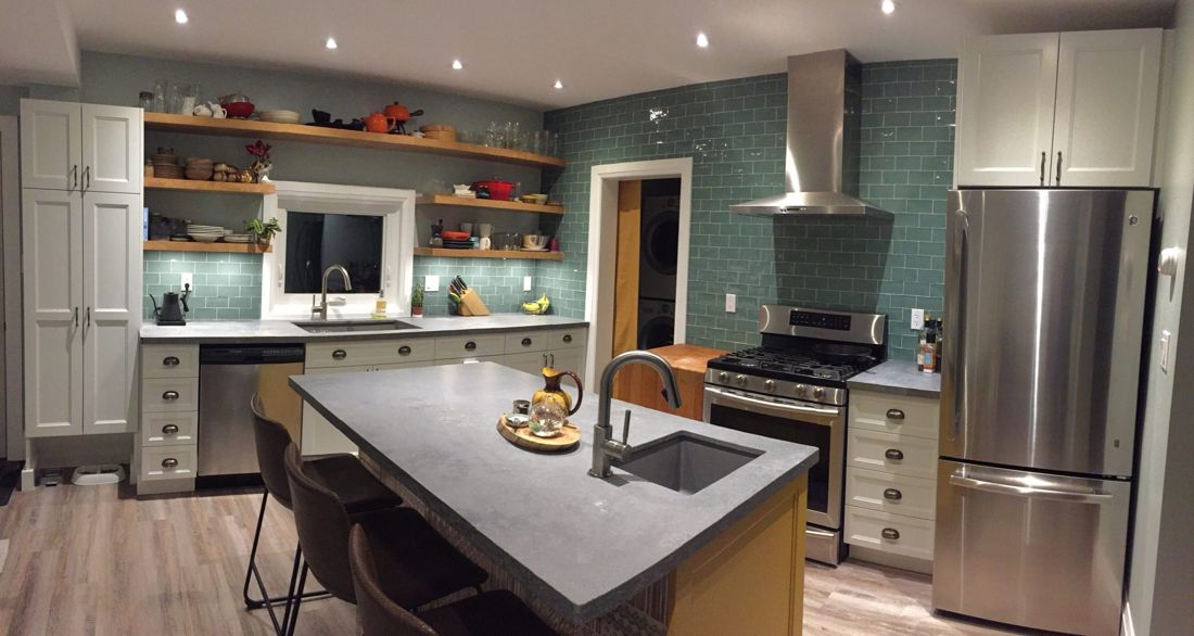 An island kitchen with layered lighting